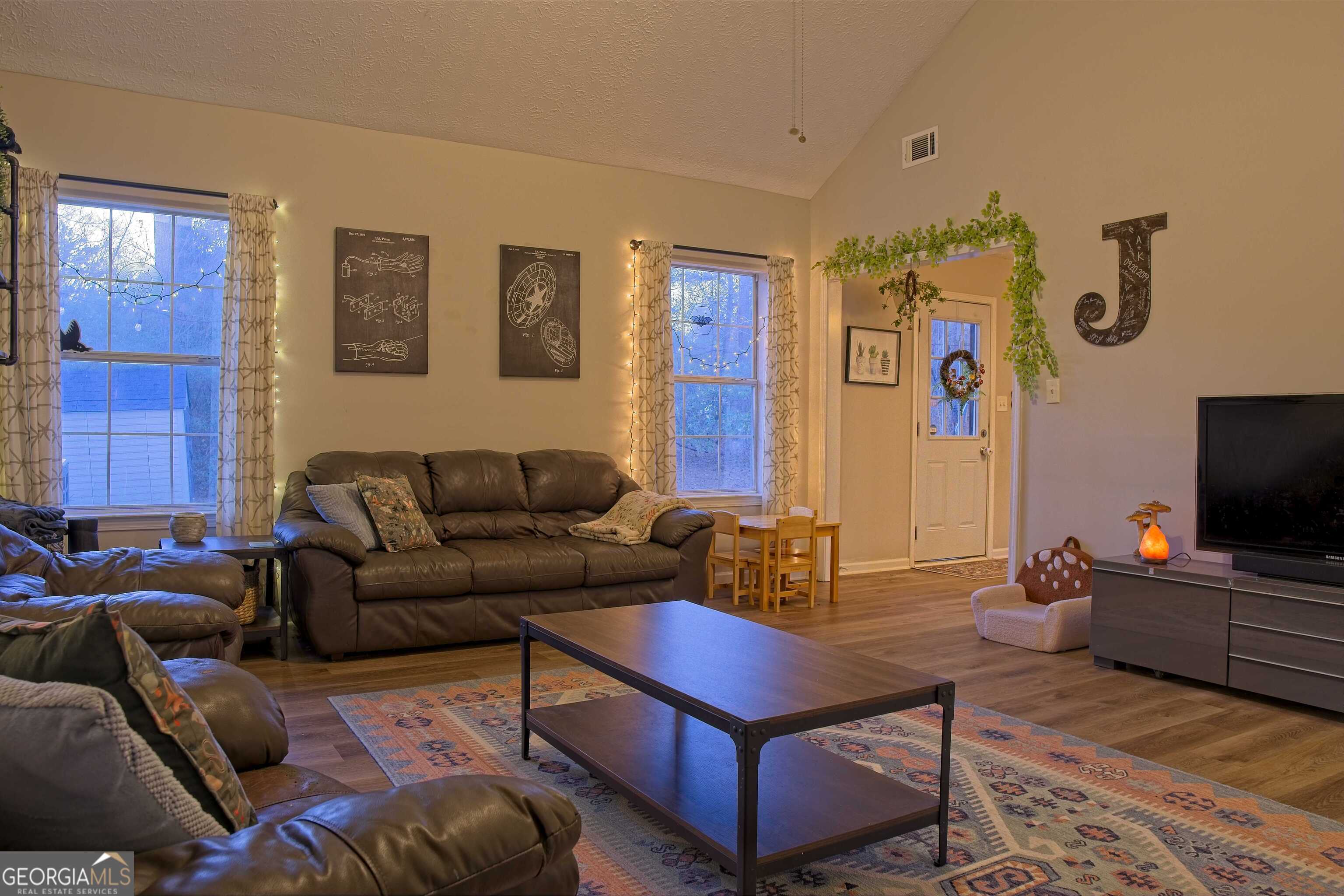 705 Baker Road Oxford, GA 30054 - Photo 12 of 50 a living room with furniture and a flat screen tv