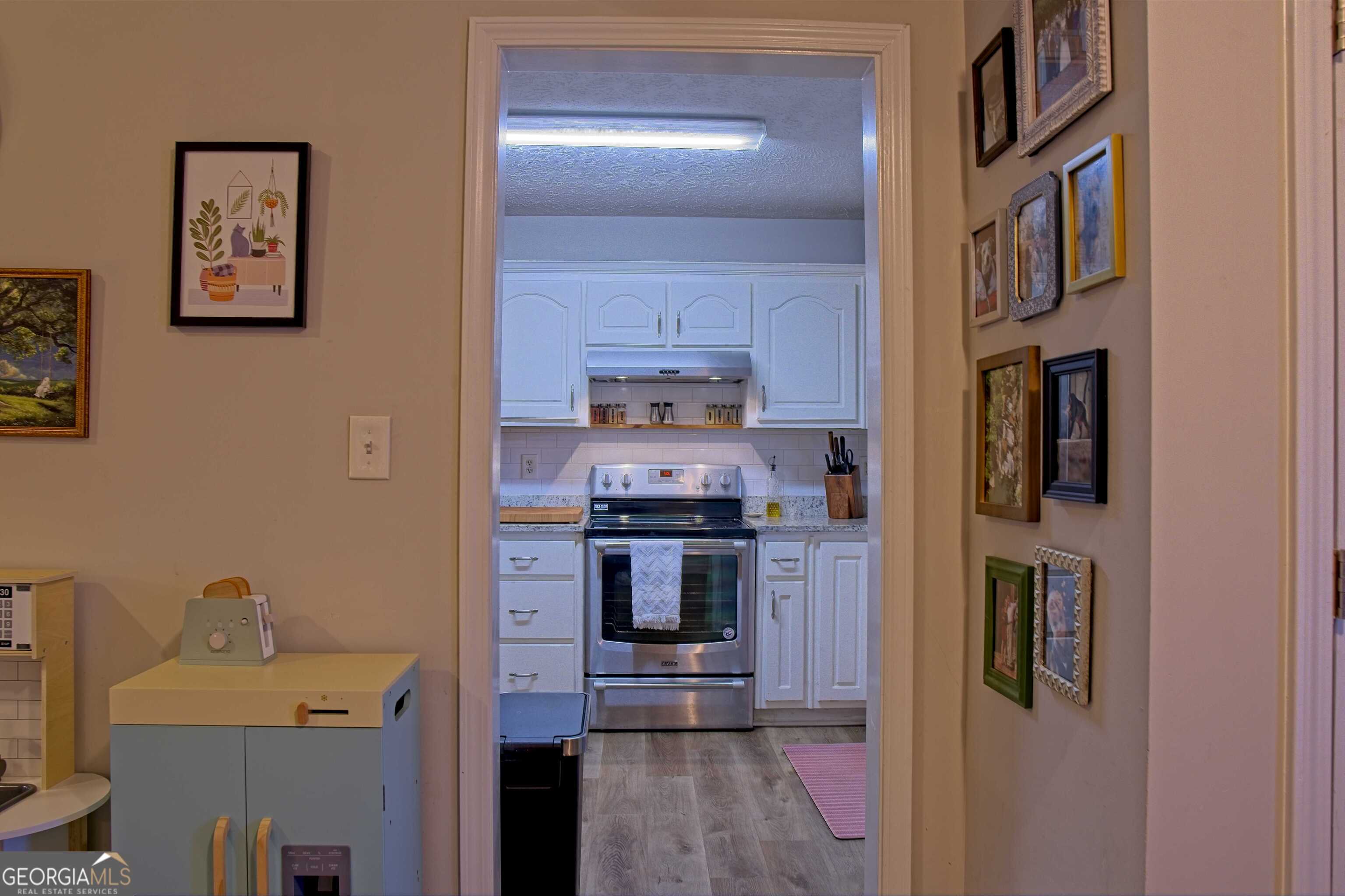 705 Baker Road Oxford, GA 30054 - Photo 13 of 50 a kitchen with stainless steel appliances granite countertop a stove and a refrigerator