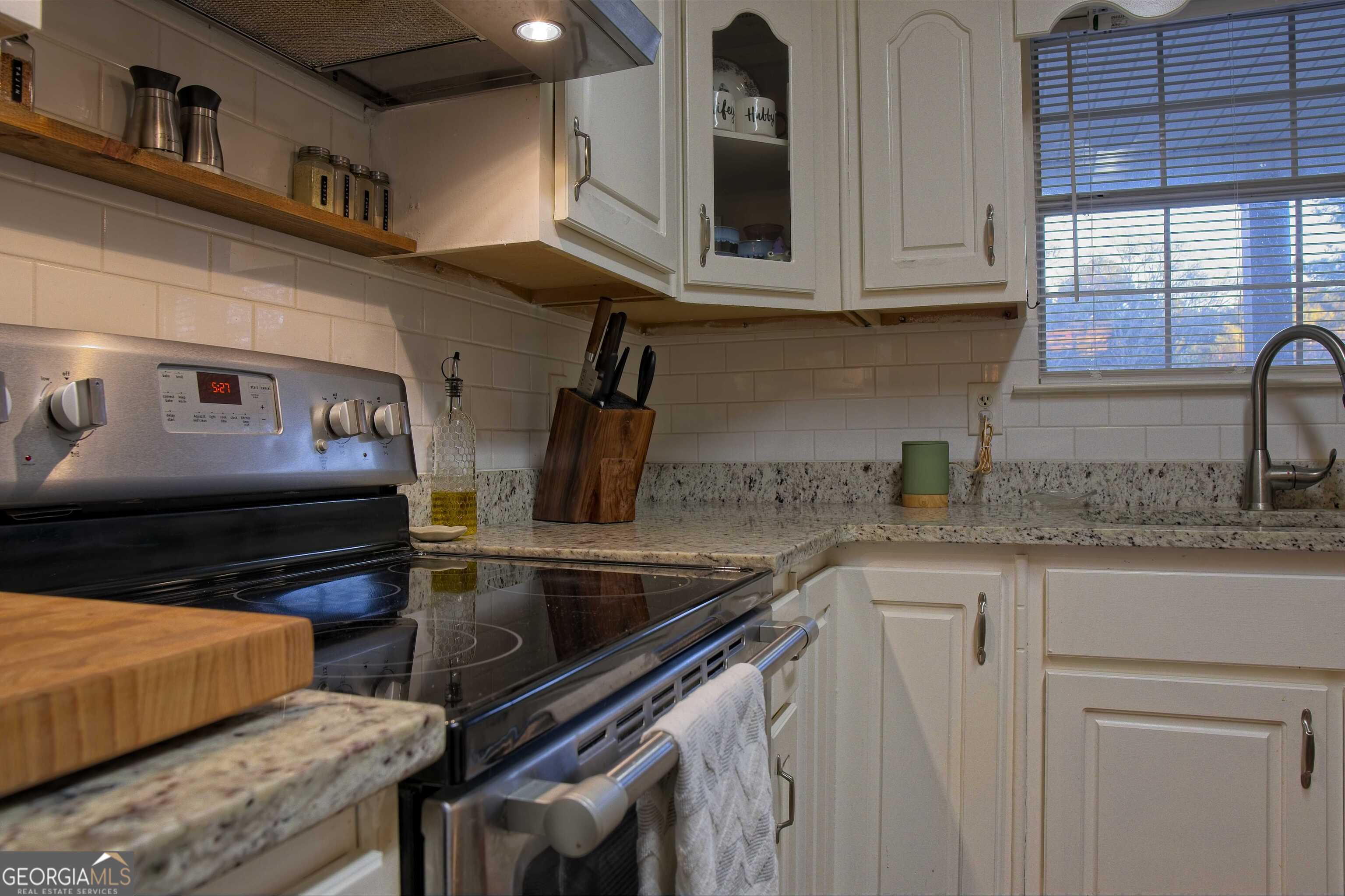 705 Baker Road Oxford, GA 30054 - Photo 16 of 50 a kitchen with stainless steel appliances granite countertop a sink and a stove