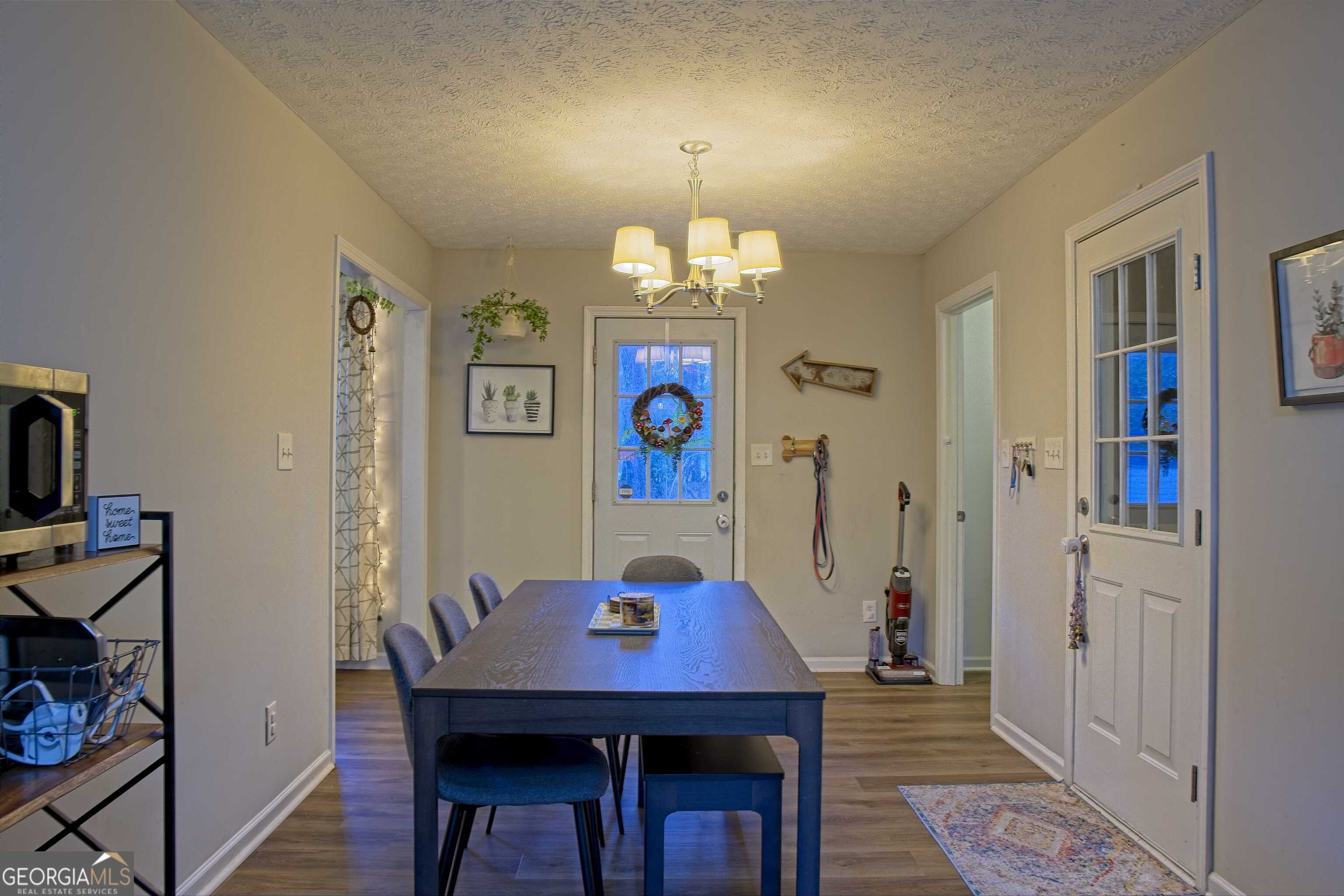 705 Baker Road Oxford, GA 30054 - Photo 19 of 50 a view of a dining room with furniture wooden floor and a chandelier