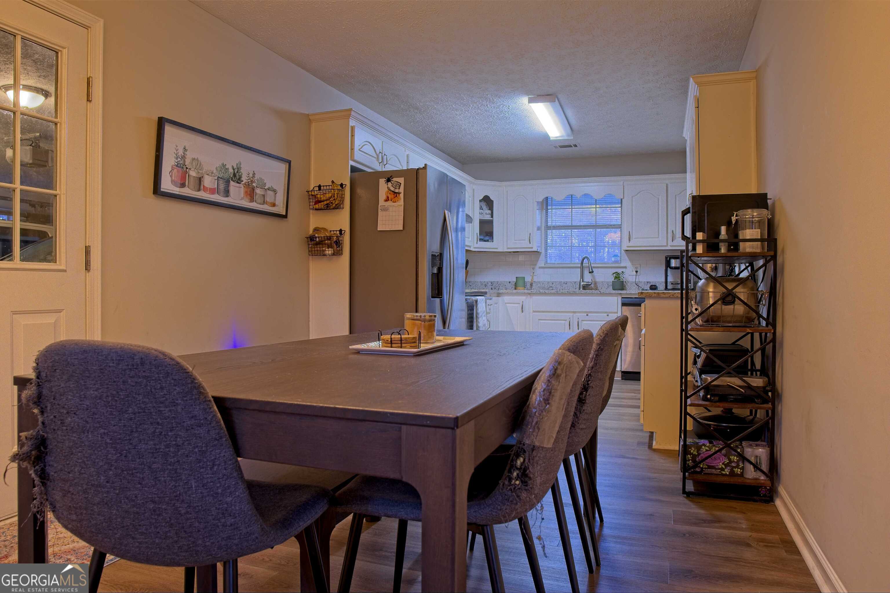 705 Baker Road Oxford, GA 30054 - Photo 20 of 50 a view of a dining room with furniture and wooden floor