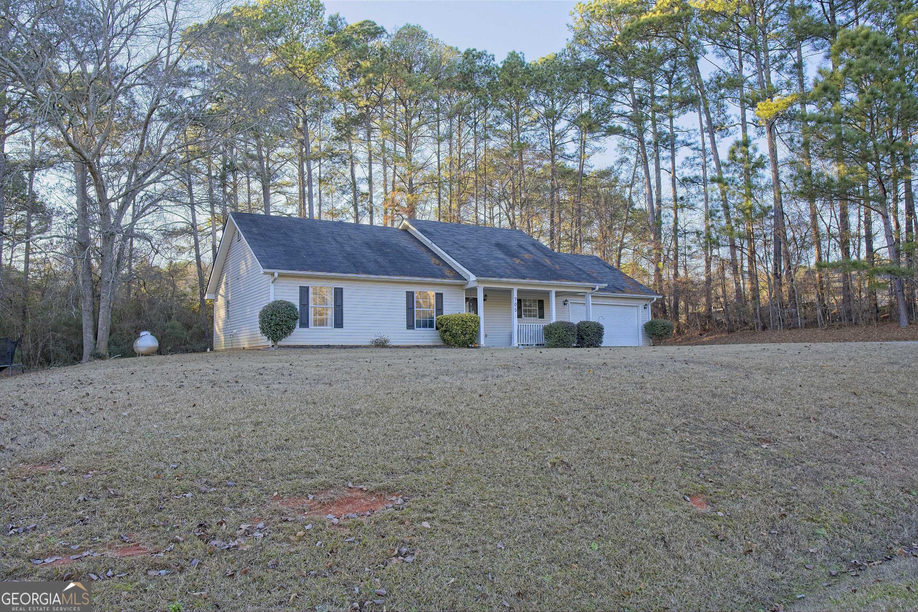 705 Baker Road Oxford, GA 30054 - Photo 2 of 50 a house with trees in the background