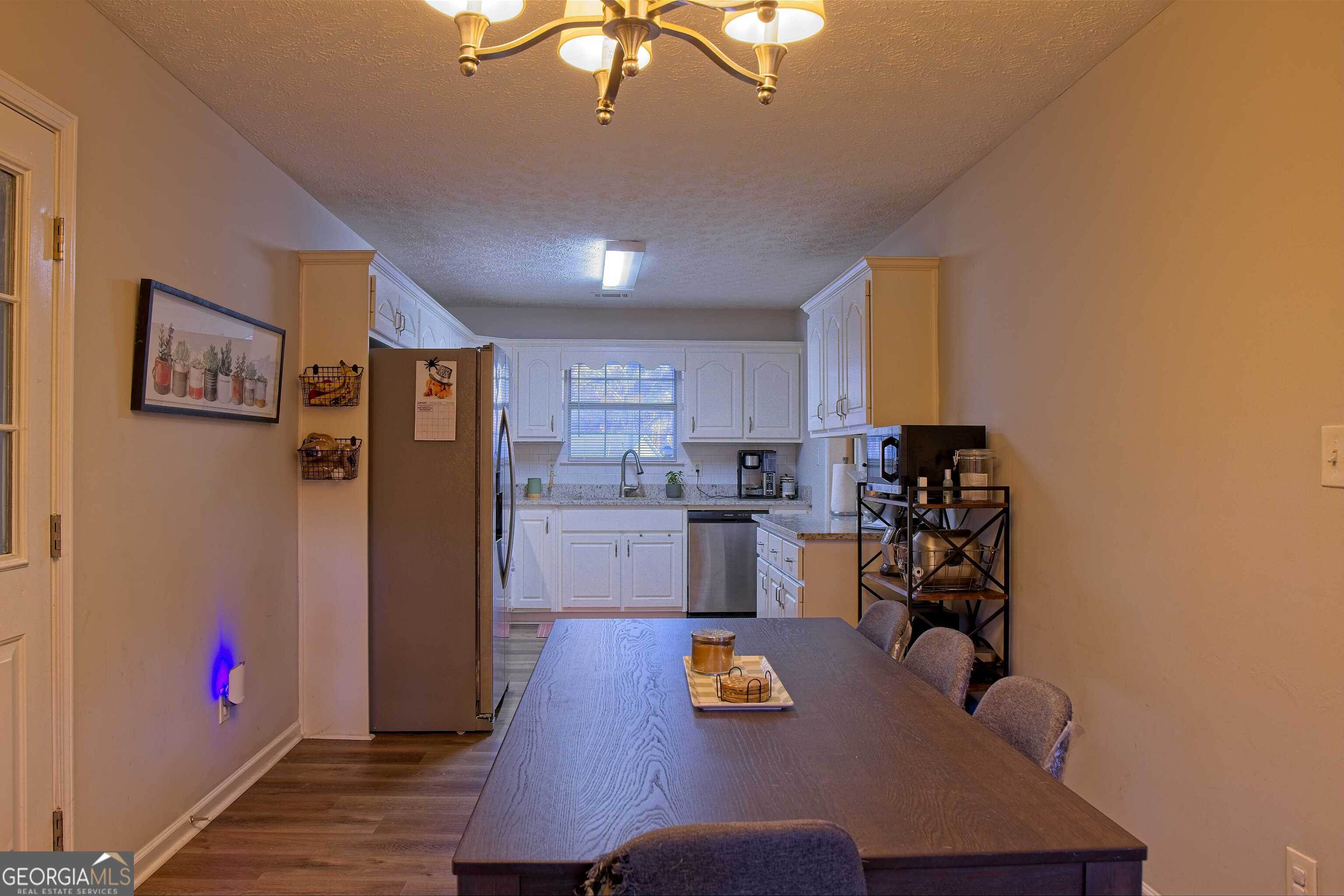 705 Baker Road Oxford, GA 30054 - Photo 22 of 50 a kitchen with stainless steel appliances granite countertop a refrigerator and microwave