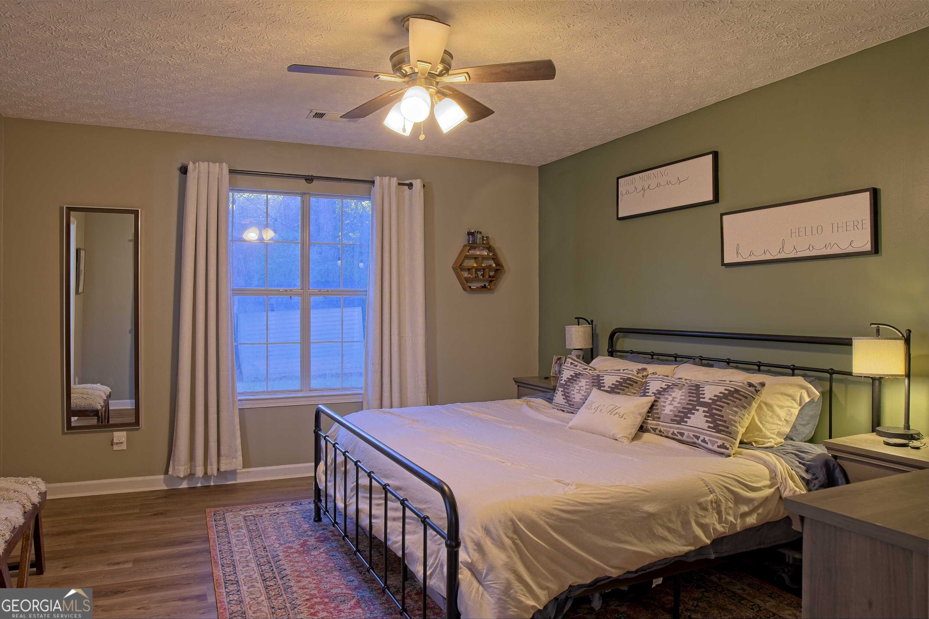 705 Baker Road Oxford, GA 30054 - Photo 24 of 50 a bedroom with a bed and a chandelier