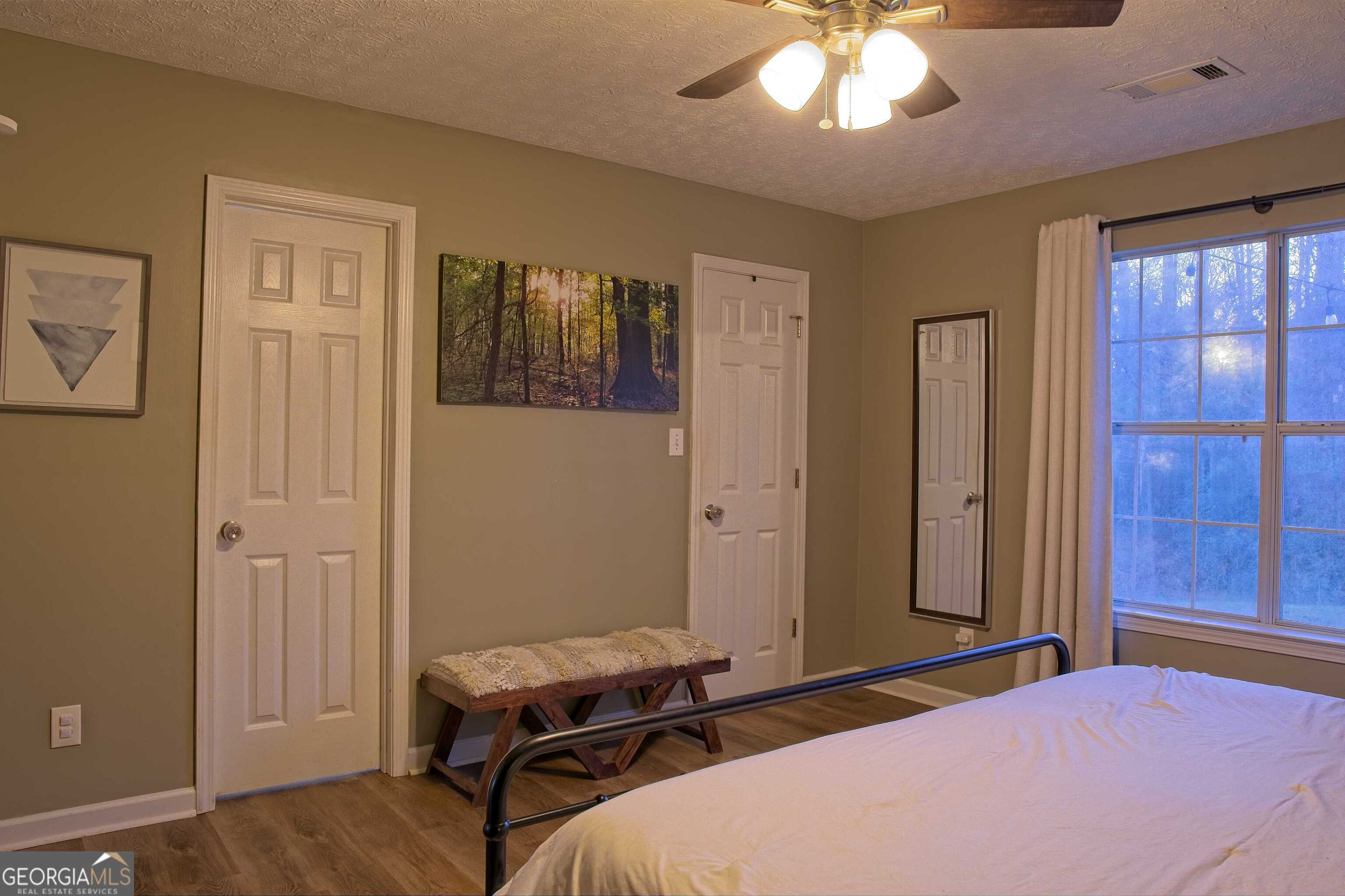 705 Baker Road Oxford, GA 30054 - Photo 28 of 50 a bedroom with a bed and wooden floor