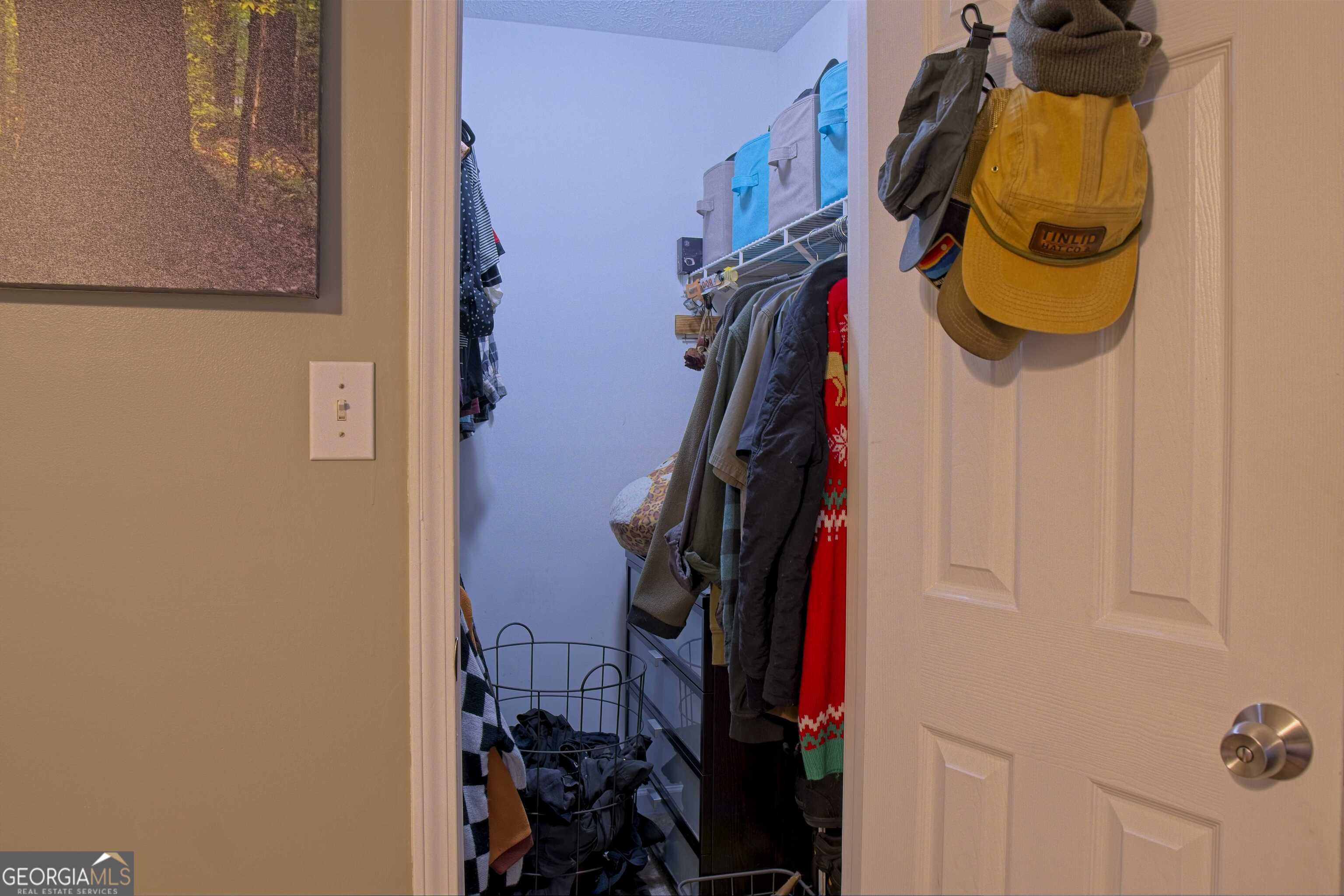 705 Baker Road Oxford, GA 30054 - Photo 32 of 50 a view of walk in closet with clothes and shoes