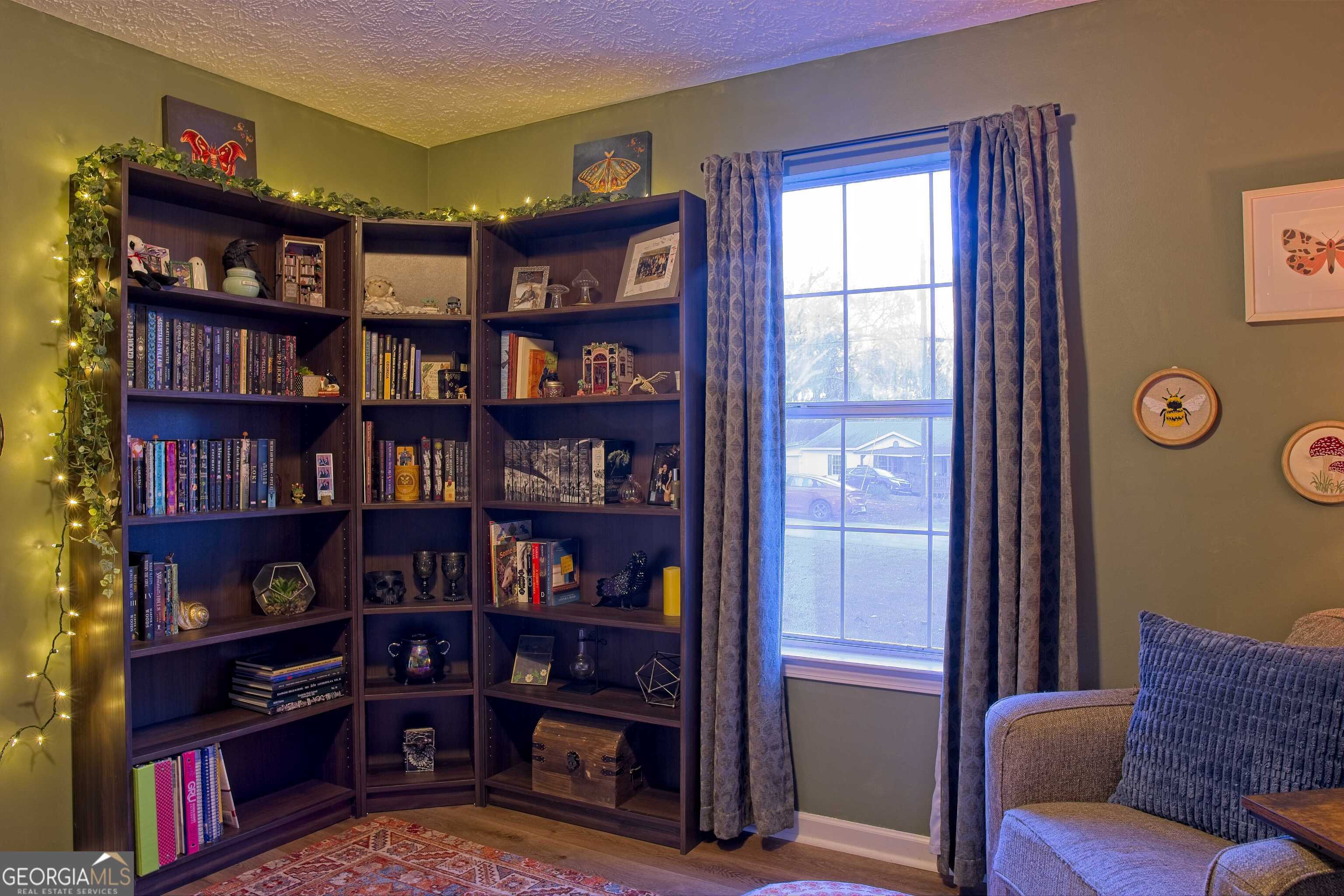 705 Baker Road Oxford, GA 30054 - Photo 33 of 50 a view of a livingroom with furniture and a bookshelf