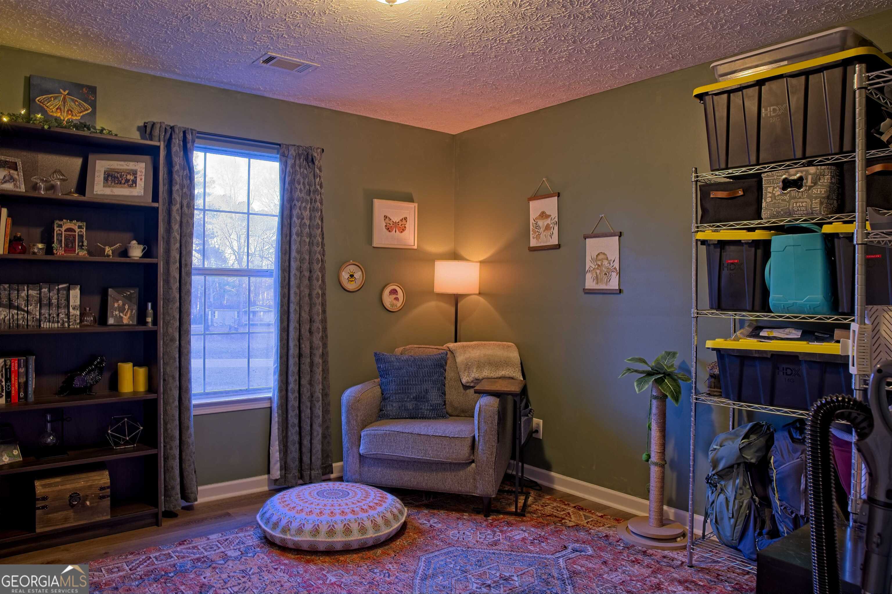 705 Baker Road Oxford, GA 30054 - Photo 35 of 50 a living room with furniture and a book shelf