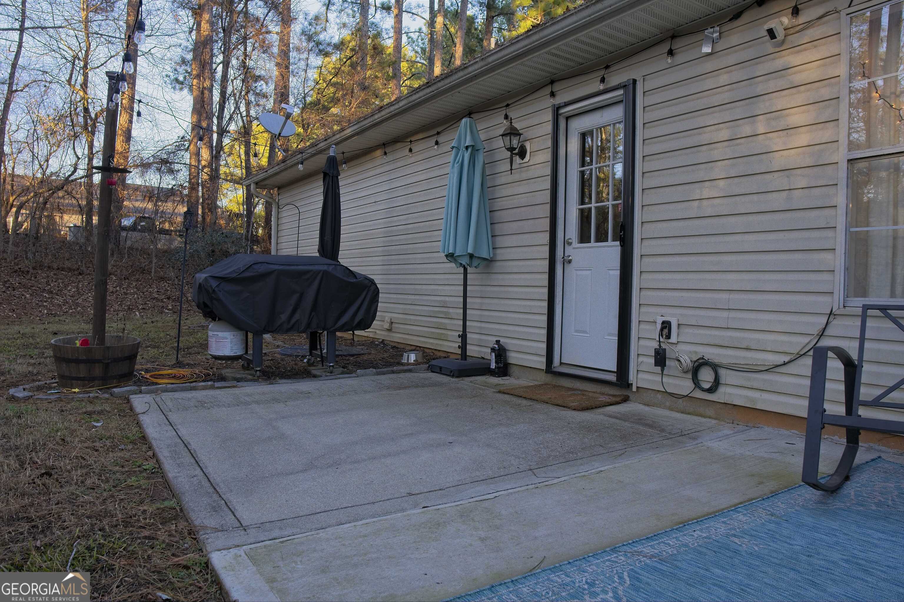 705 Baker Road Oxford, GA 30054 - Photo 42 of 50 a backyard of a house with barbeque oven table and chairs