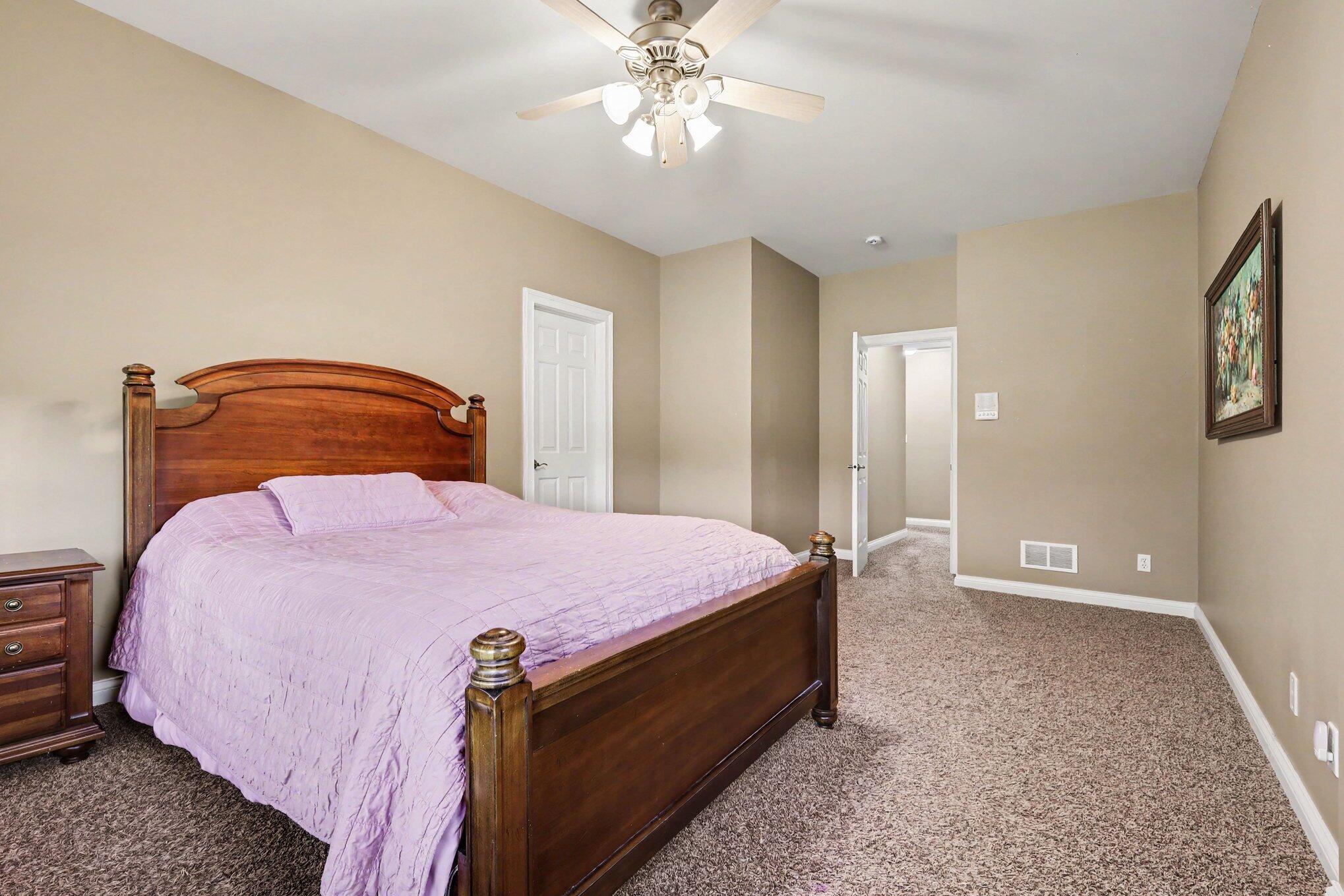 10195 Floyd Street Crown Point, IN 46307 - Photo 16 of 20 a bedroom with a bed and a chandelier