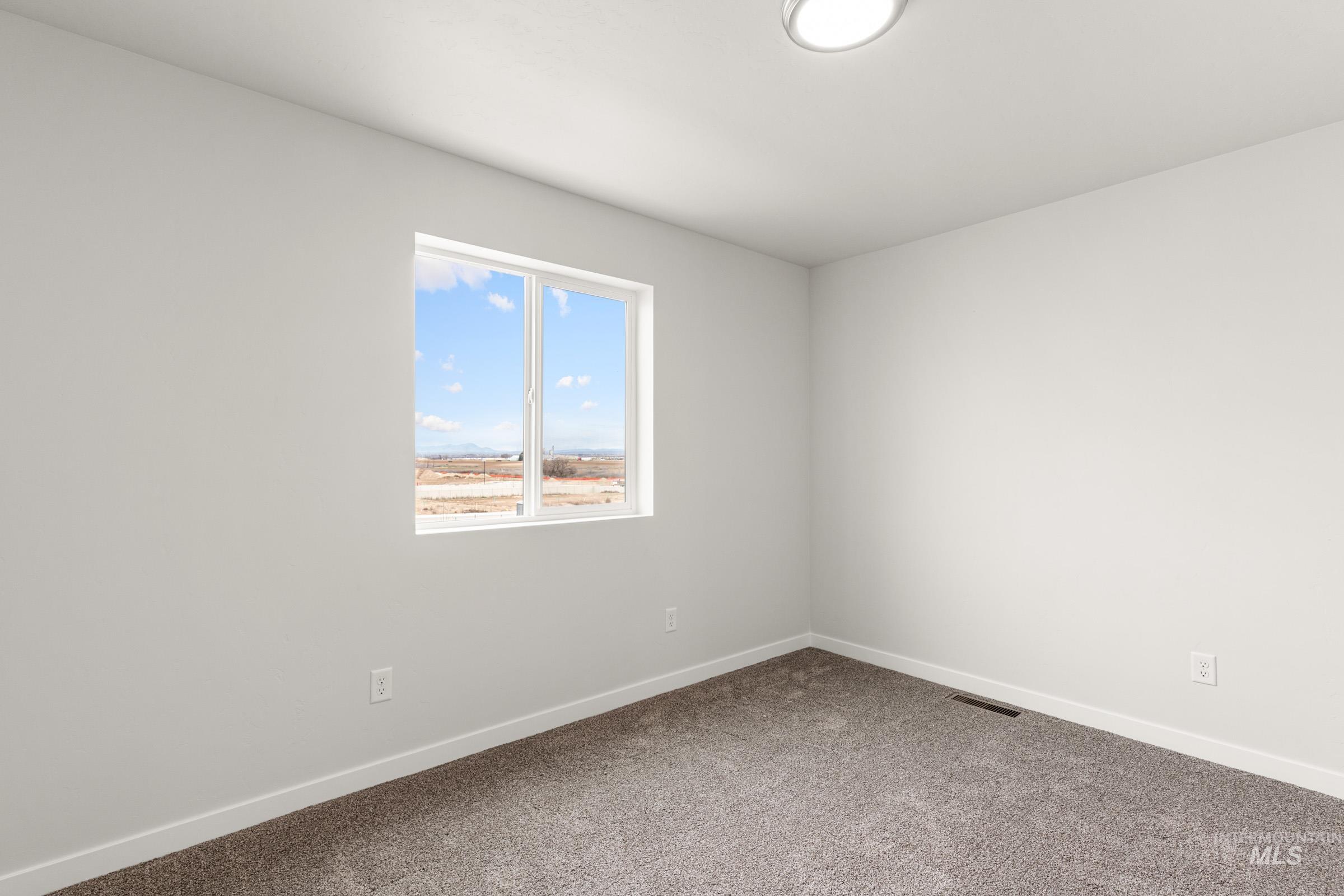 10832 Rutland Street Caldwell, ID 83605 - Photo 11 of 20 Empty room featuring baseboards and carpet floors