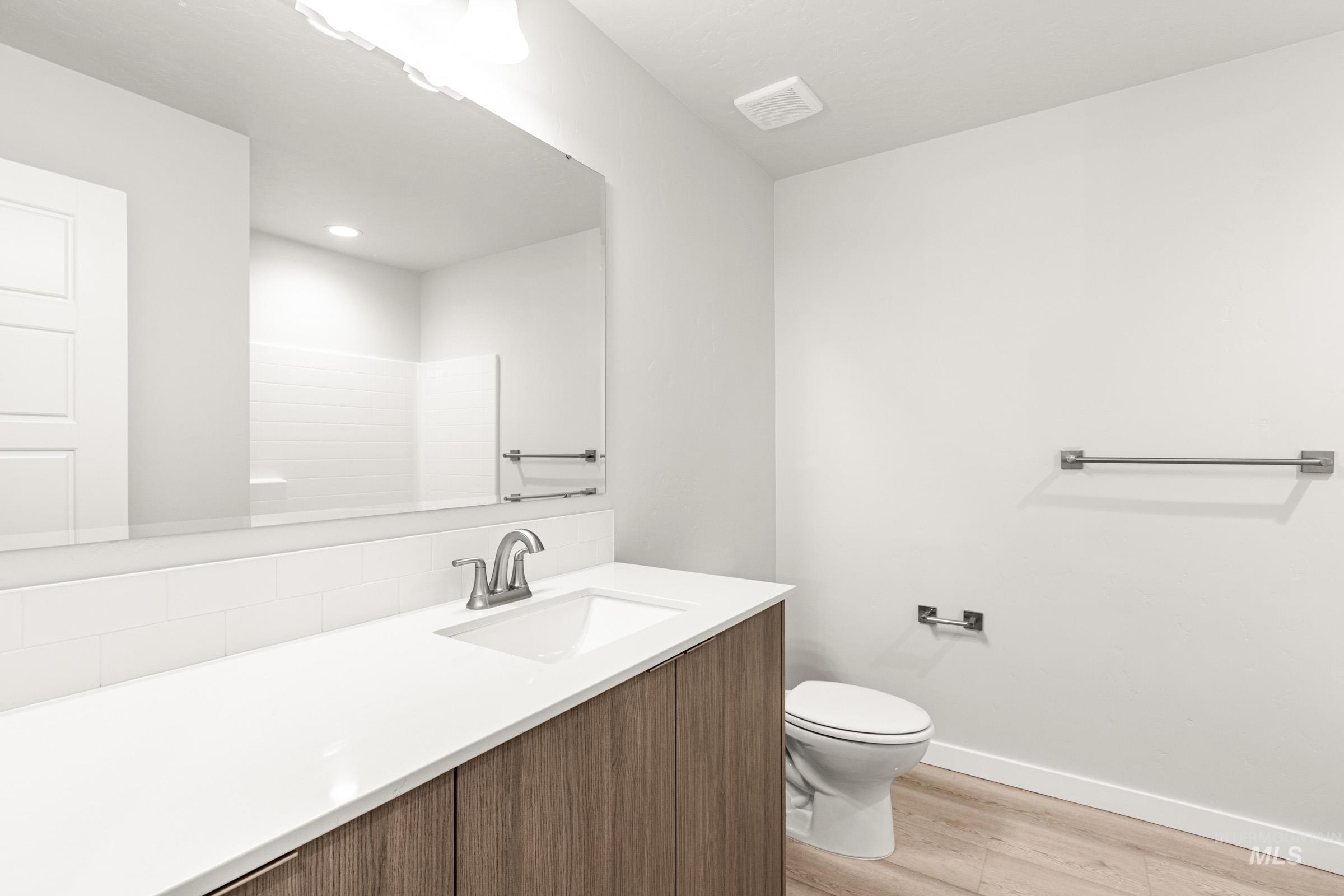 10832 Rutland Street Caldwell, ID 83605 - Photo 12 of 20 Bathroom featuring vanity and light wood-style flooring