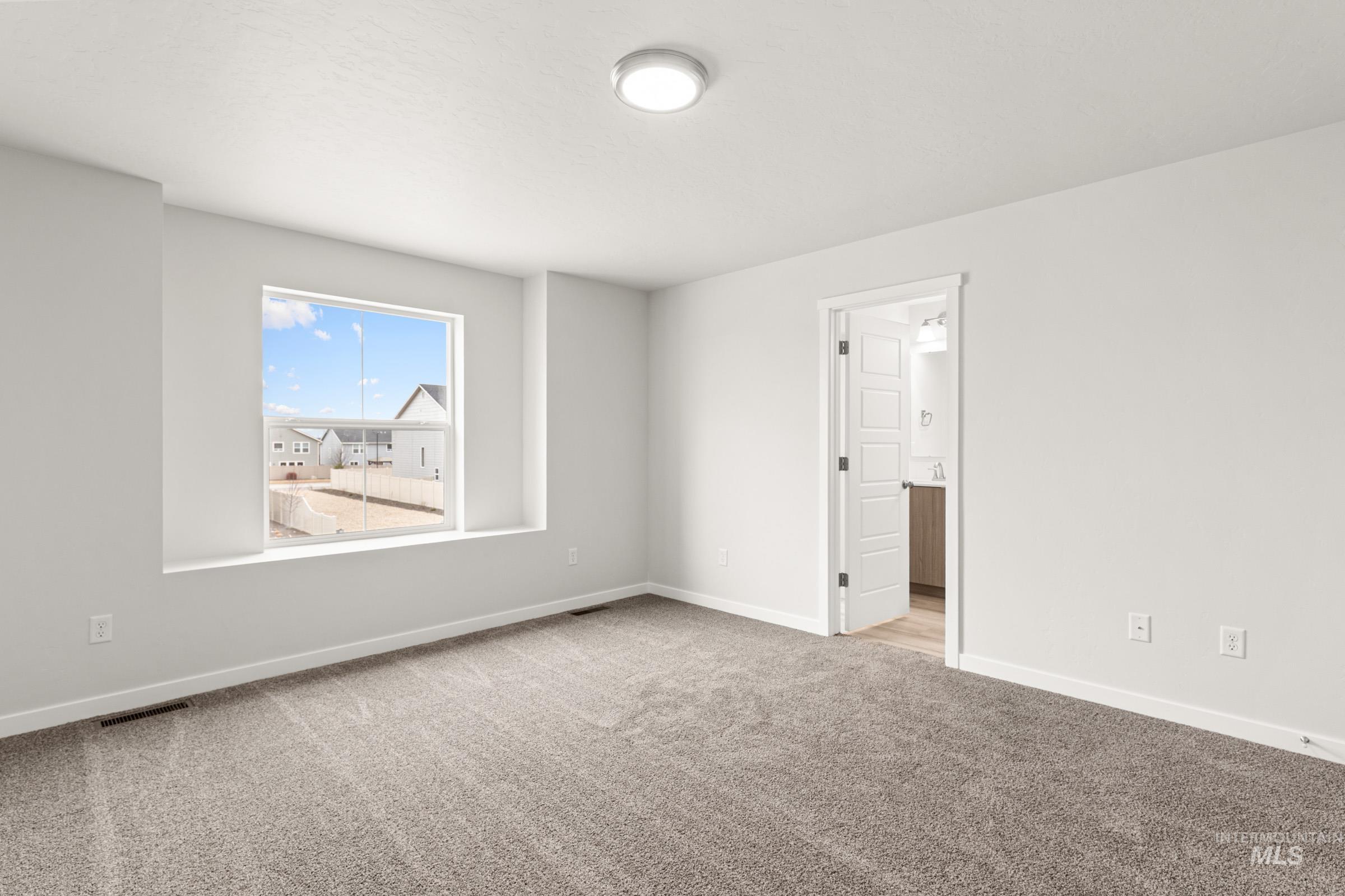 10832 Rutland Street Caldwell, ID 83605 - Photo 14 of 20 Empty room featuring light colored carpet and baseboards