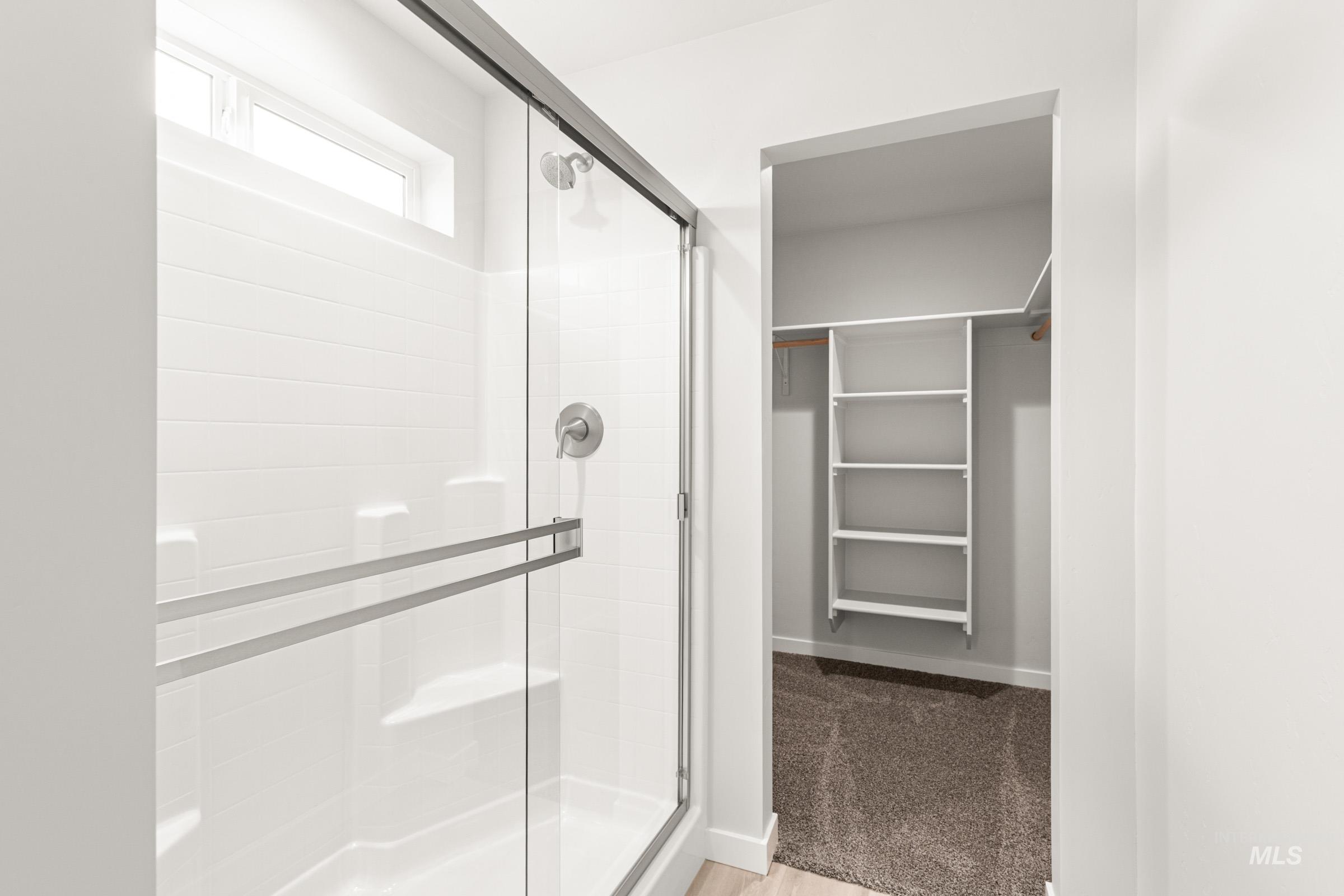 10832 Rutland Street Caldwell, ID 83605 - Photo 15 of 20 Full bathroom with a shower stall, a spacious closet, and light wood-style floors