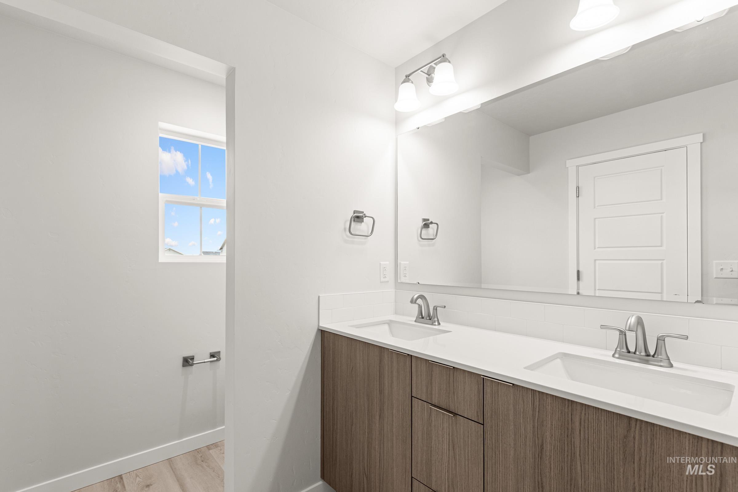 10832 Rutland Street Caldwell, ID 83605 - Photo 17 of 20 Bathroom featuring double vanity and light wood-style floors