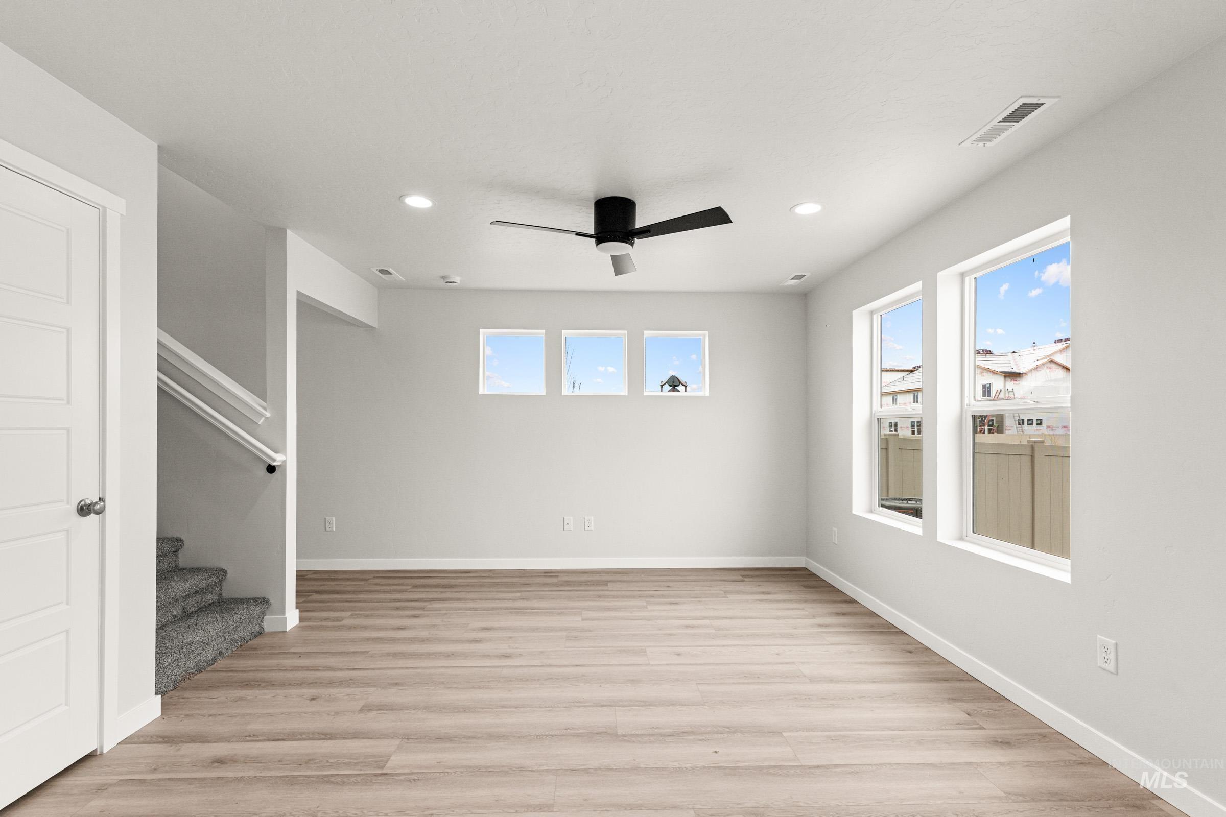10832 Rutland Street Caldwell, ID 83605 - Photo 7 of 20 Unfurnished living room with a ceiling fan, light wood-style floors, and recessed lighting