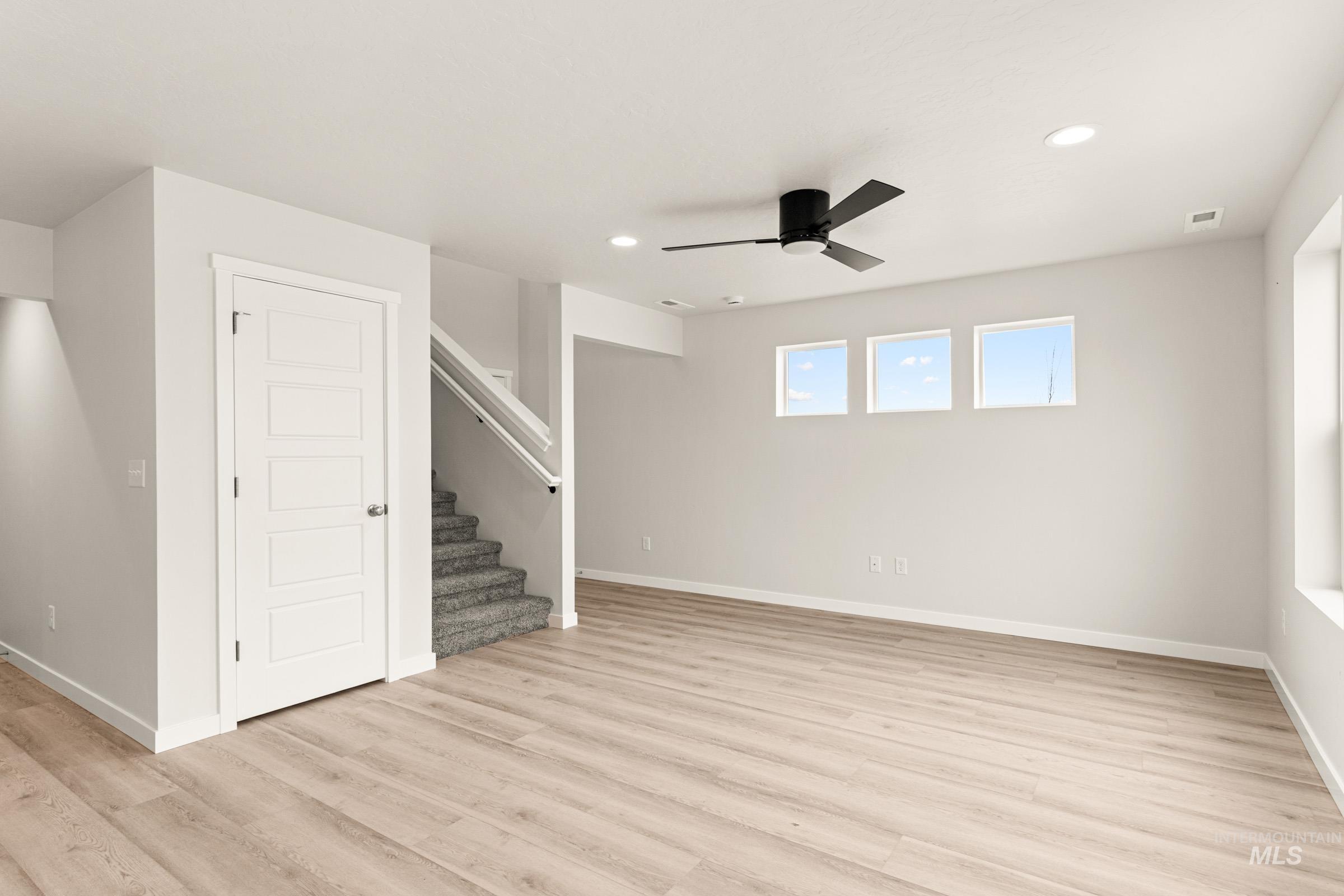 10832 Rutland Street Caldwell, ID 83605 - Photo 8 of 20 Unfurnished living room featuring a ceiling fan, recessed lighting, and light wood-type flooring