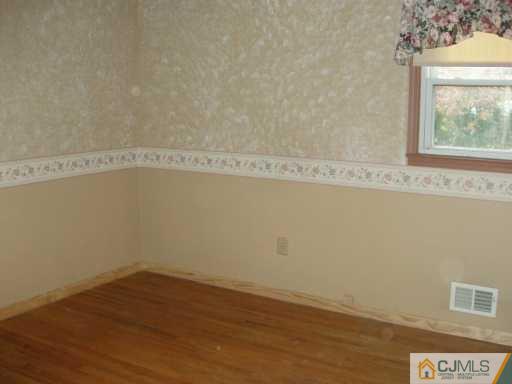 611 Inman Avenue Colonia, NJ 07067 - Photo 4 of 7 a view of a small space with wooden floor and a window