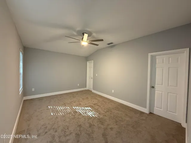 a view of an empty room with a fan