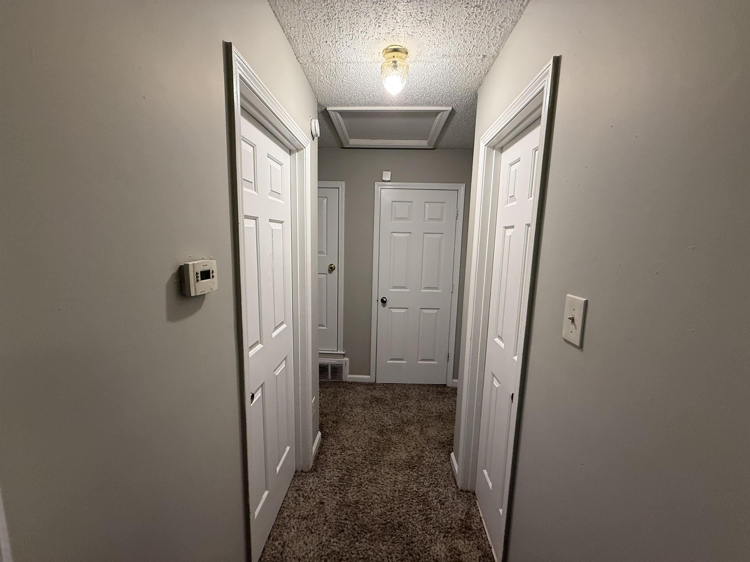 6420 Saginaw Road Memphis, TN 38134 - Photo 14 of 38 Hallway featuring neutral wall paint and textured carpeting
