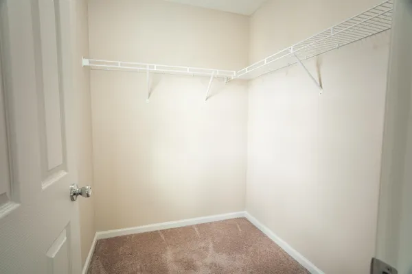 a bathroom with a granite countertop toilet and a sink