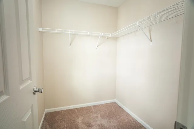 a bathroom with a granite countertop toilet and a sink