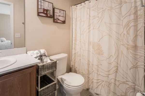 a view of a hallway with bathroom and shower