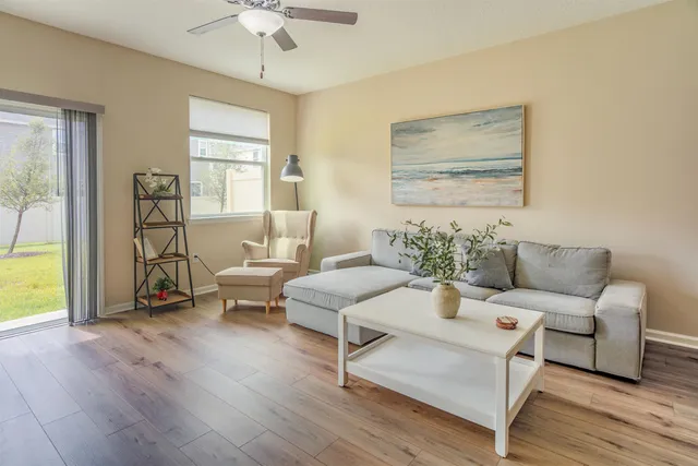 a living room with furniture and a large window