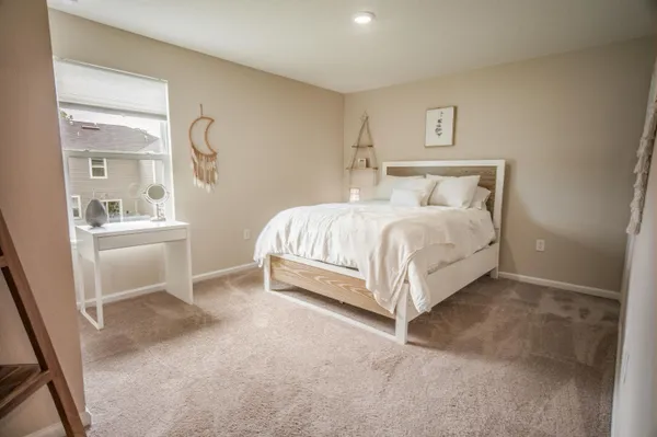 a bedroom with a bed and a window