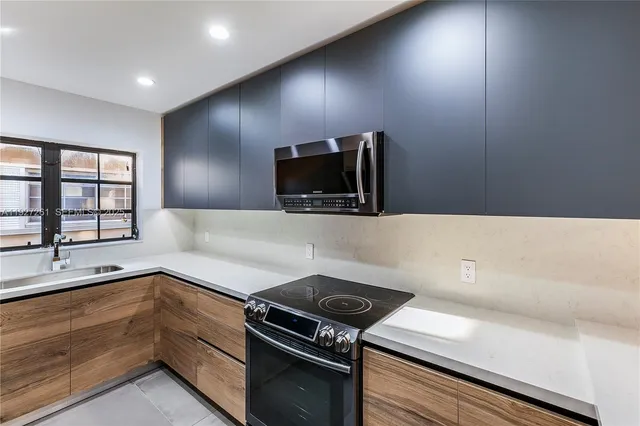 a kitchen with a sink and a stove top oven
