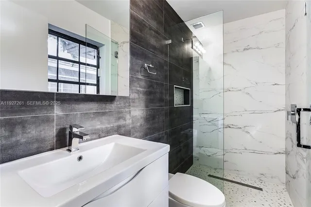 a bathroom with a sink toilet and shower