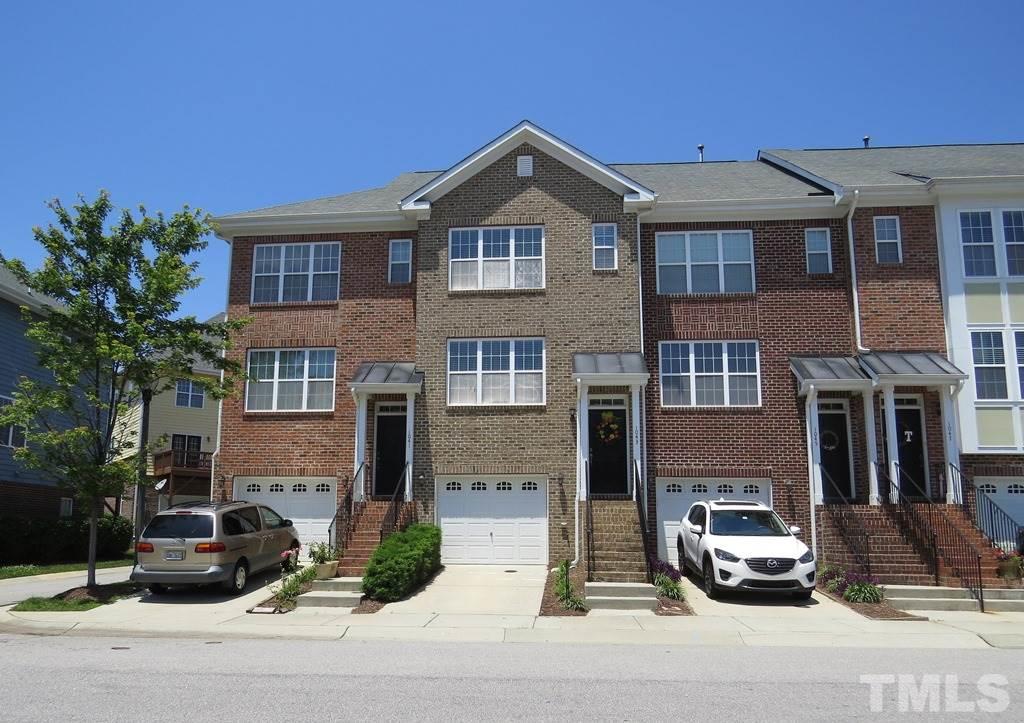 1043 Summerhouse Road Cary, NC 27519 - Photo 1 of 24 a front view of a house with car parked