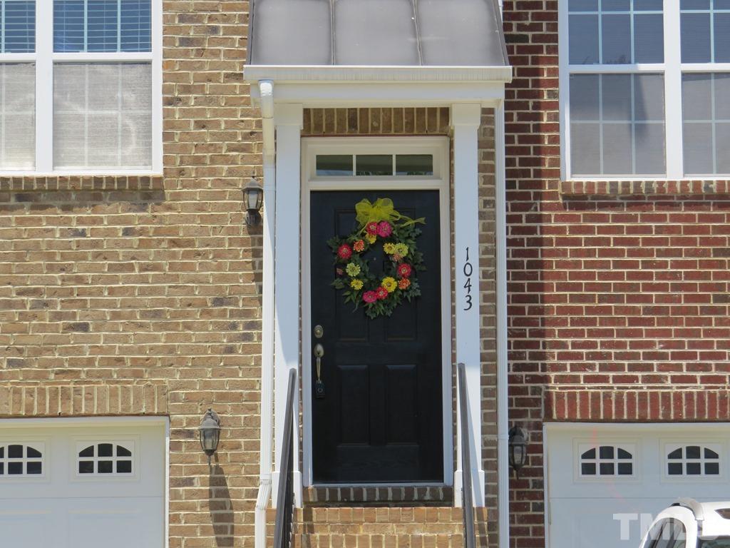 1043 Summerhouse Road Cary, NC 27519 - Photo 2 of 24 a front view of a house with a door and a window
