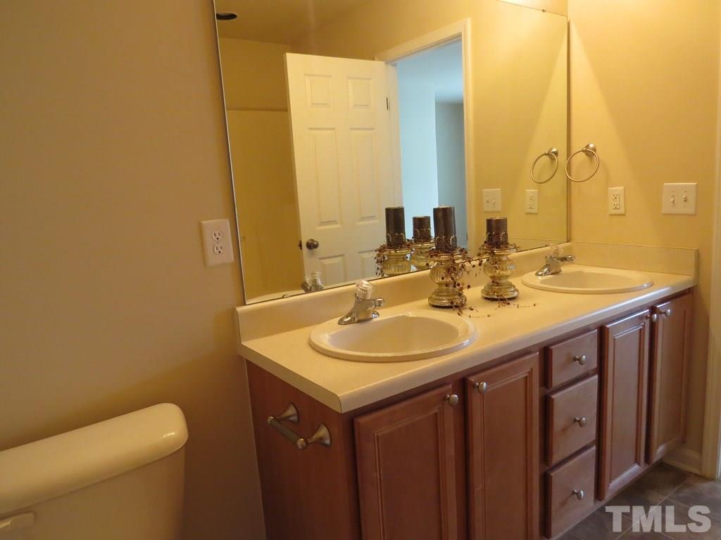 1043 Summerhouse Road Cary, NC 27519 - Photo 12 of 24 a bathroom with a sink and a mirror