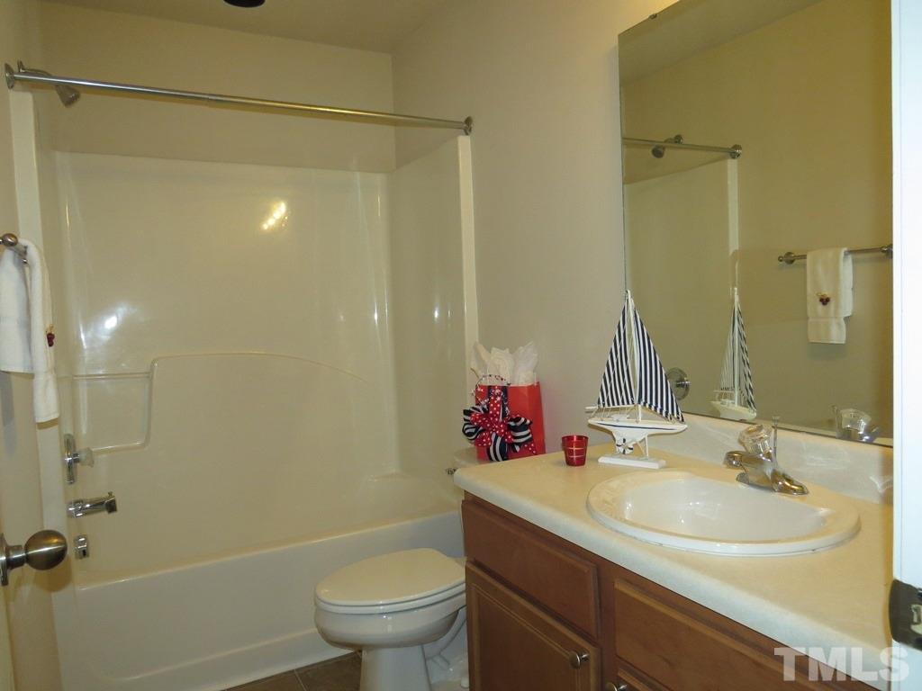 1043 Summerhouse Road Cary, NC 27519 - Photo 13 of 24 a bathroom with a sink toilet double vanity and shower