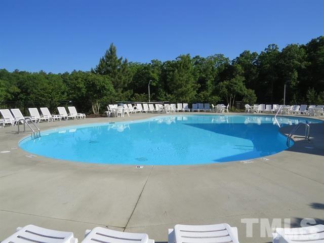 1043 Summerhouse Road Cary, NC 27519 - Photo 17 of 24 a view of a swimming pool with a yard