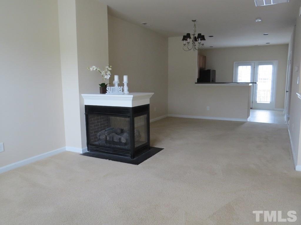 1043 Summerhouse Road Cary, NC 27519 - Photo 3 of 24 a view of an empty room and fire place