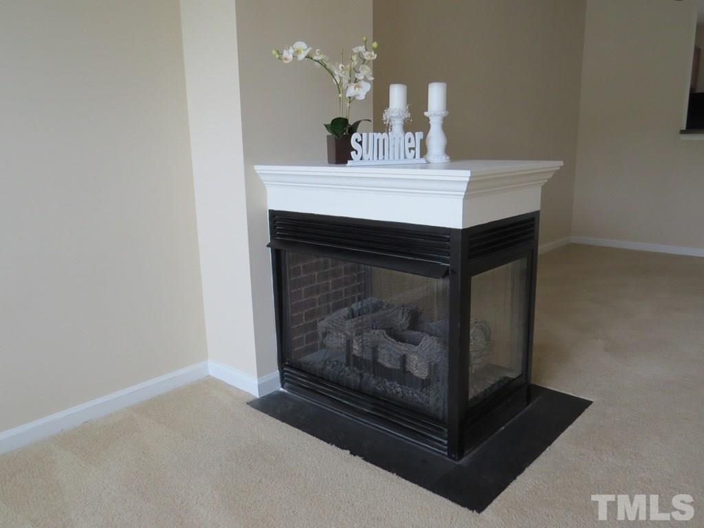 1043 Summerhouse Road Cary, NC 27519 - Photo 4 of 24 a room with a fireplace and a mirror