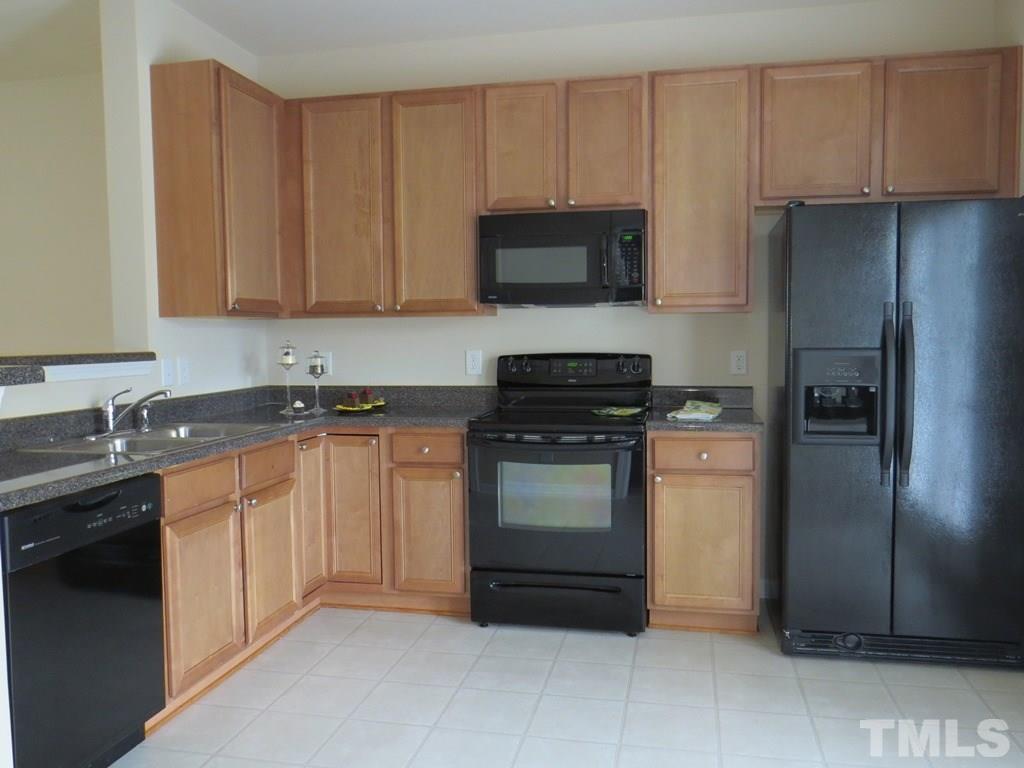 1043 Summerhouse Road Cary, NC 27519 - Photo 5 of 24 a kitchen with stainless steel appliances granite countertop a refrigerator stove and sink