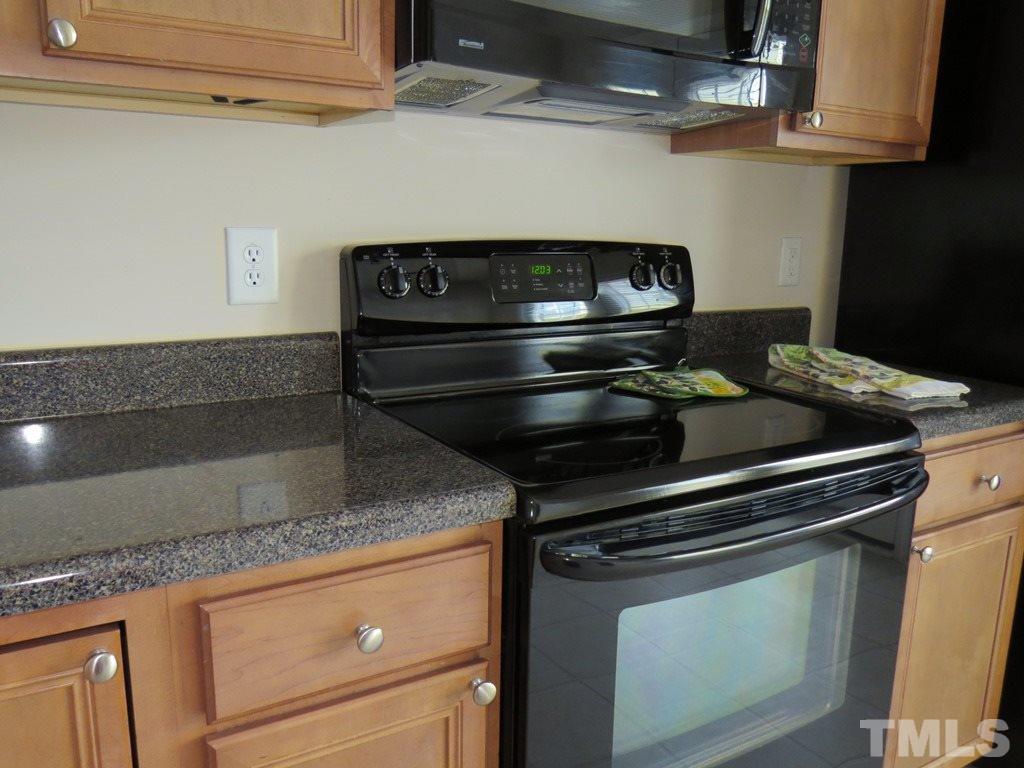 1043 Summerhouse Road Cary, NC 27519 - Photo 6 of 24 a stove top oven sitting inside of a kitchen