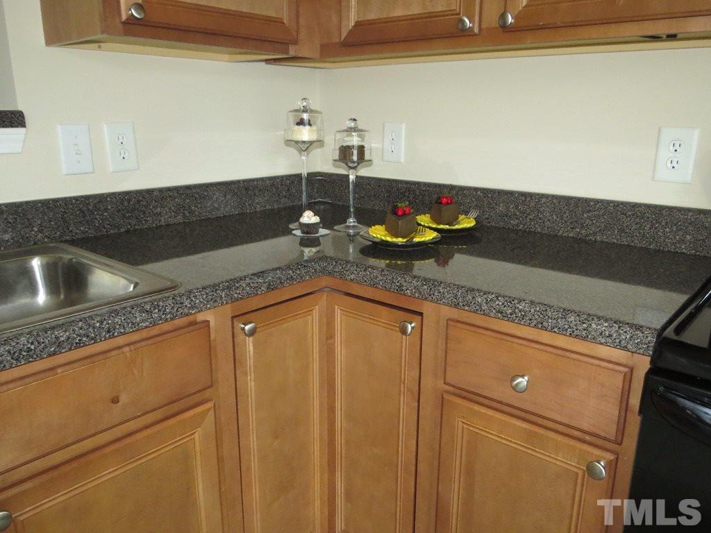1043 Summerhouse Road Cary, NC 27519 - Photo 8 of 24 a kitchen with a sink and a granite counter tops