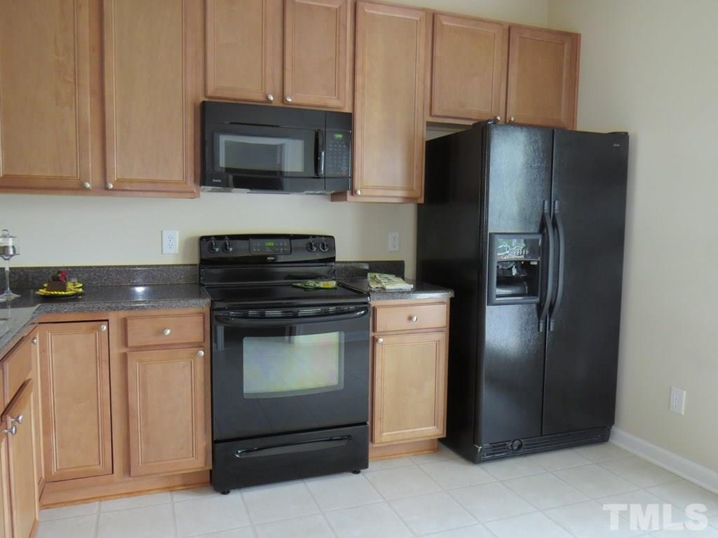 1043 Summerhouse Road Cary, NC 27519 - Photo 9 of 24 a kitchen with stainless steel appliances granite countertop a refrigerator stove and microwave