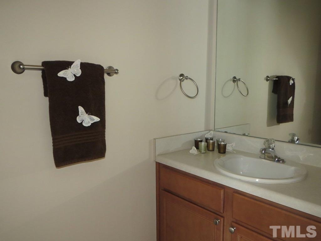 1043 Summerhouse Road Cary, NC 27519 - Photo 10 of 24 a bathroom with a sink and mirror