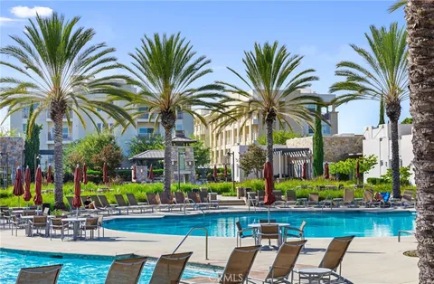 a view of a lawn chairs and a table in the patio in front of a house