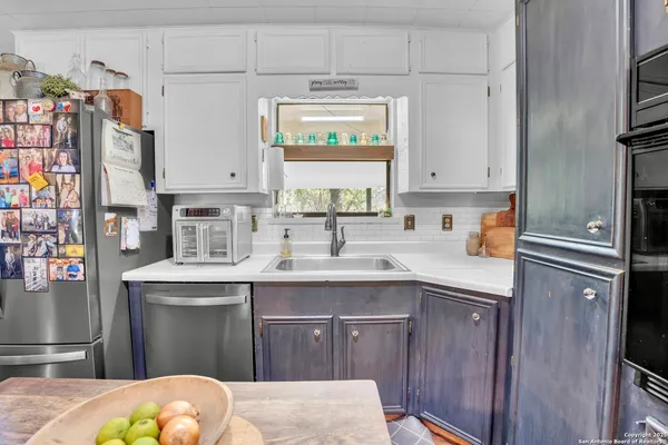 a kitchen with stainless steel appliances a sink stove and cabinets