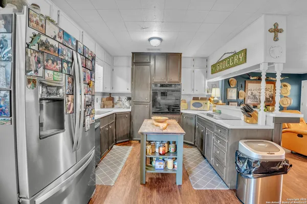 a kitchen with stainless steel appliances granite countertop a stove a sink dishwasher and a refrigerator