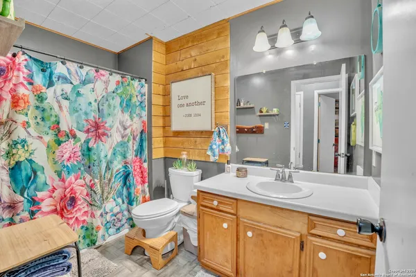 a bathroom with a sink a toilet and a mirror