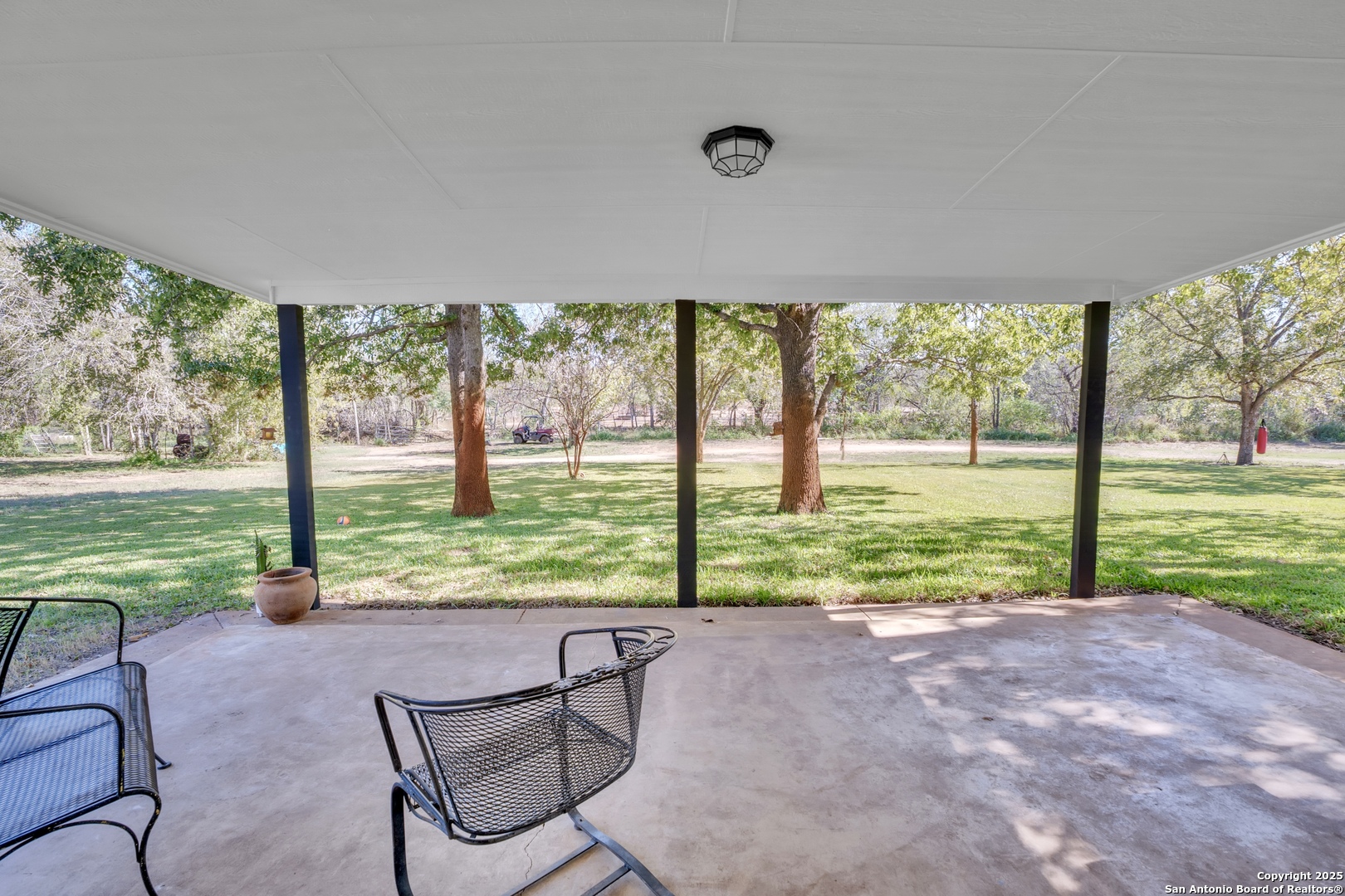 470 Rutledge Road Poteet, TX 78065 - Photo 24 of 40 a view of backyard with large trees and a big yard