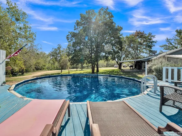 swimming pool view with a outdoor seating