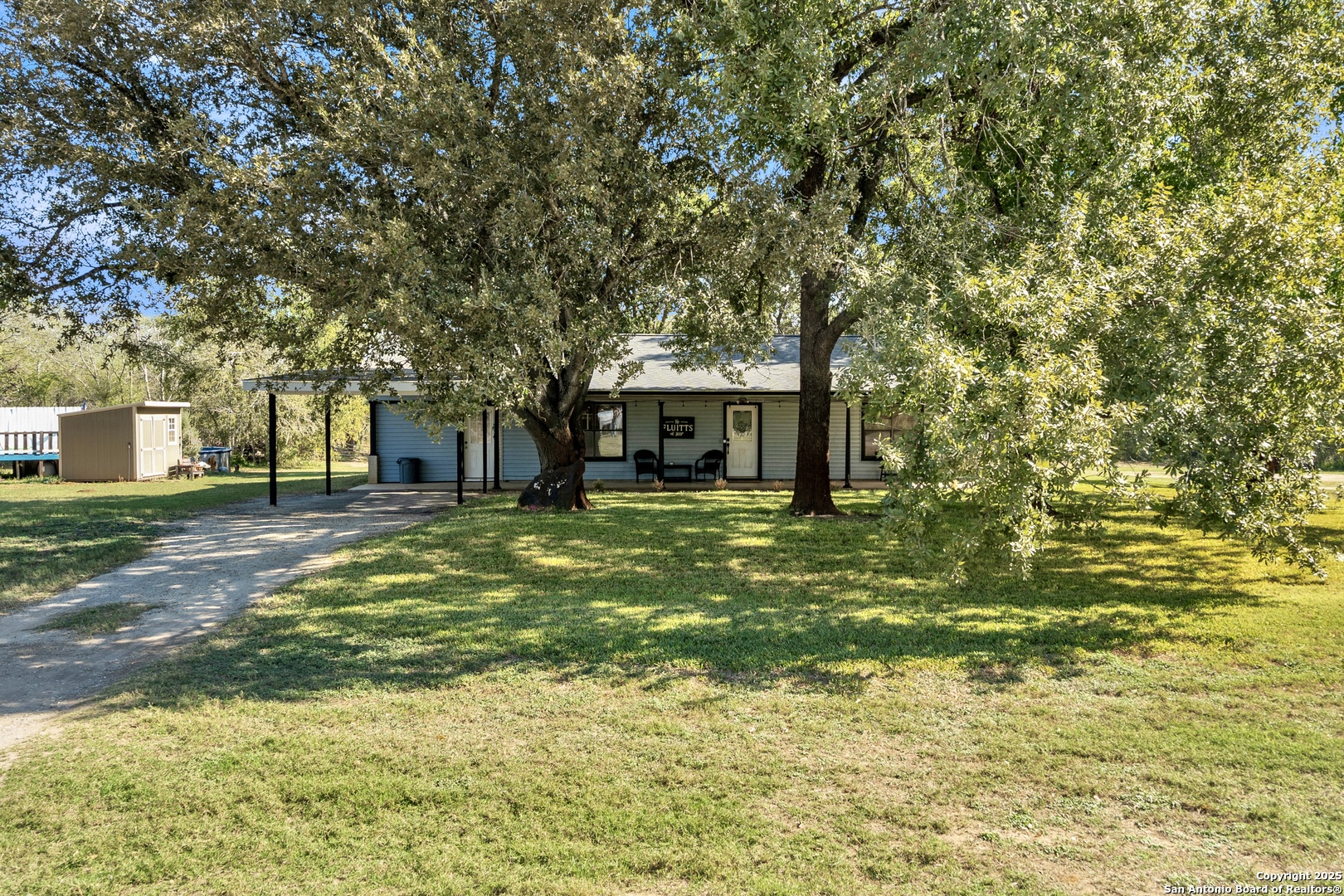 470 Rutledge Road Poteet, TX 78065 - Photo 5 of 40 a front view of a house with a garden